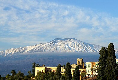 Blick über Häuser auf den Ätna-Vulkan auf Sizilien